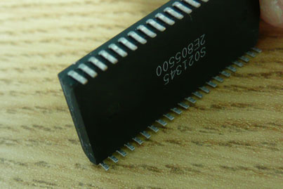 ...and then push the chip so that all the legs bend as shown.